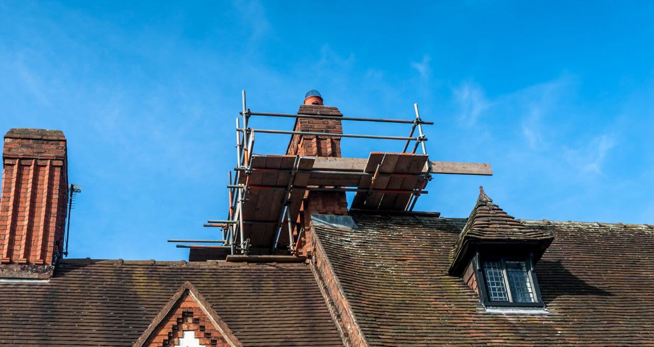 Chimney repair and flashing work on a tiled roof in Enfield